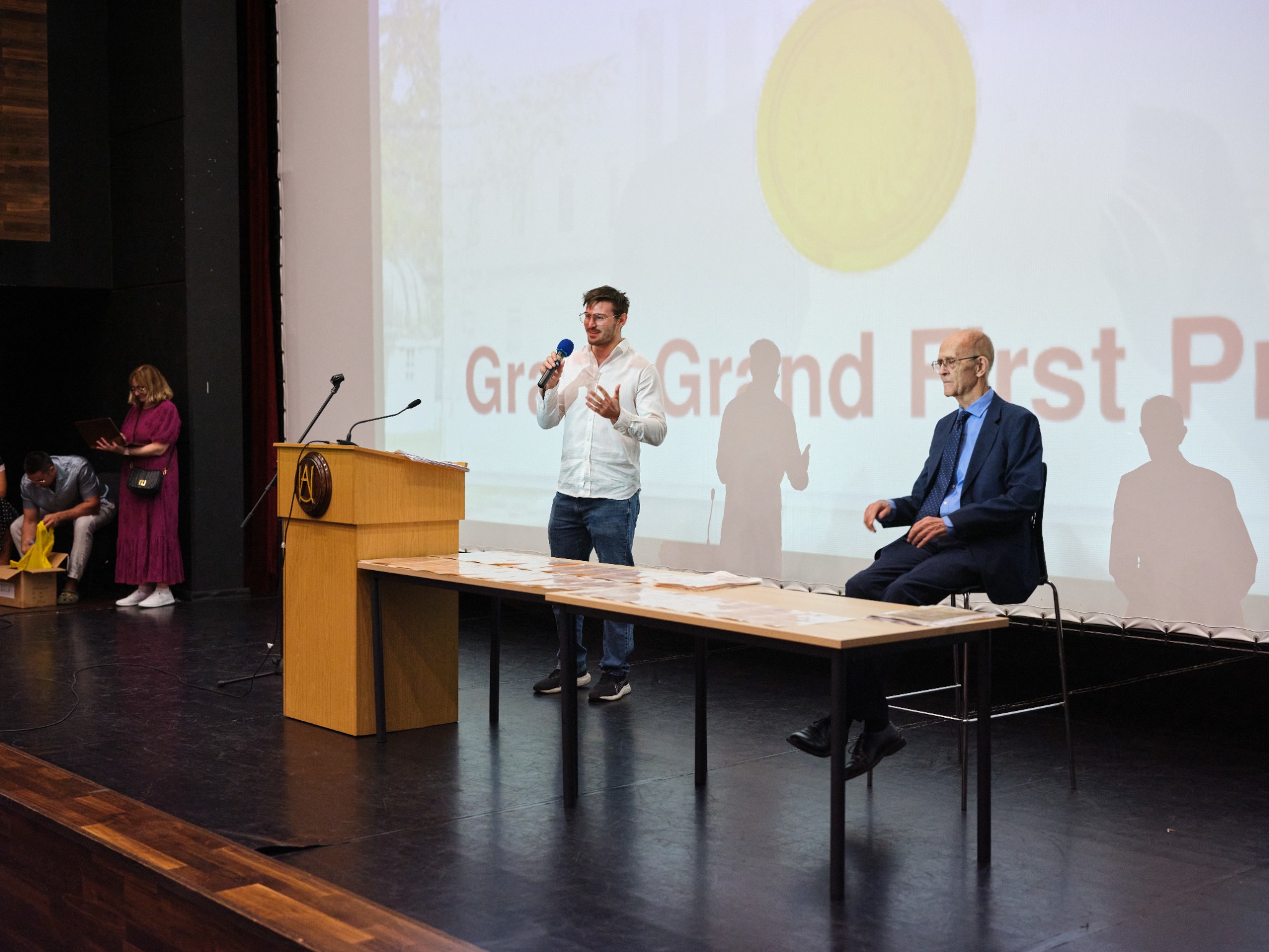 A speaker addressing participants at an IMC ceremony